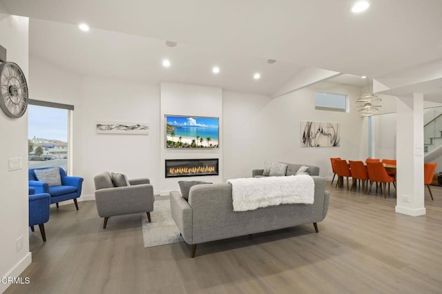 living room with ceiling fan and hardwood / wood-style floors