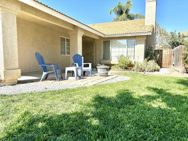 back of house featuring a patio area and a yard