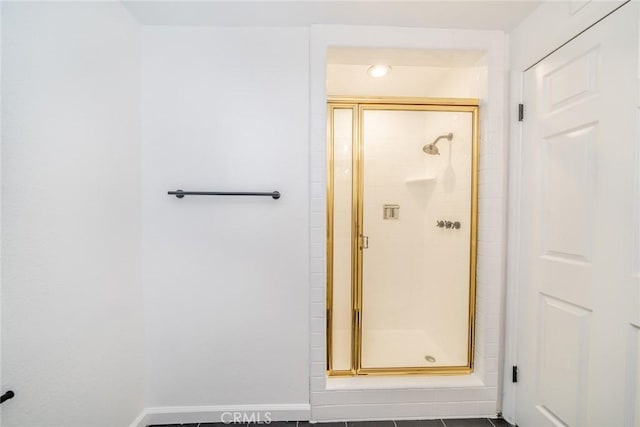 bathroom featuring tile patterned flooring and an enclosed shower