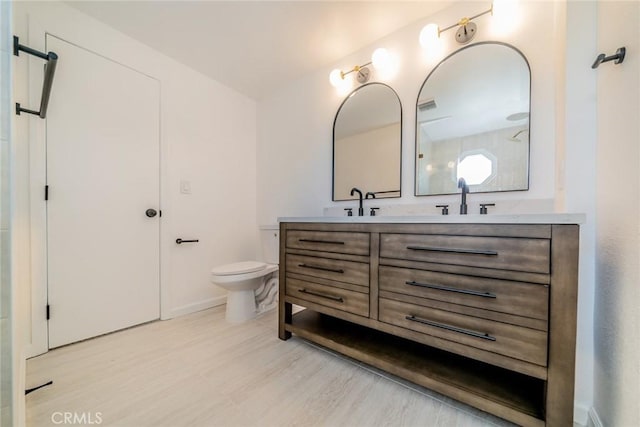 bathroom with hardwood / wood-style flooring, vanity, and toilet