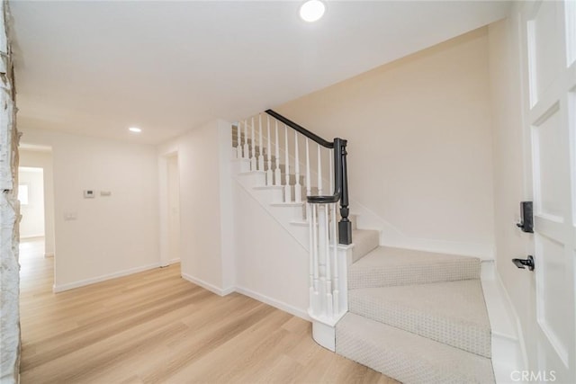 stairs with hardwood / wood-style floors