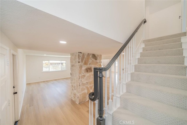 staircase featuring hardwood / wood-style floors