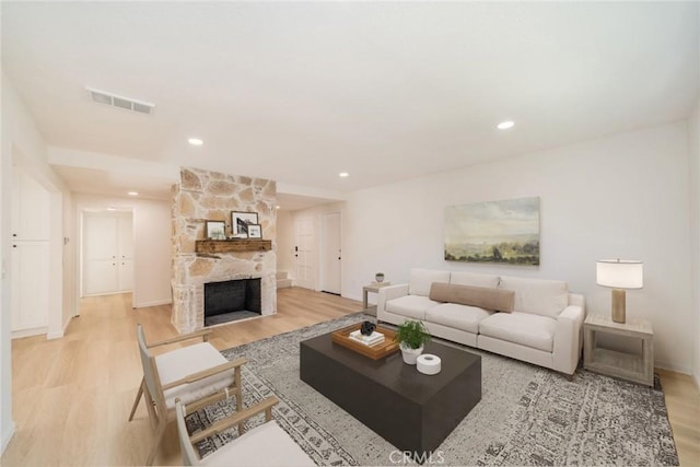 living room with a fireplace and light hardwood / wood-style floors