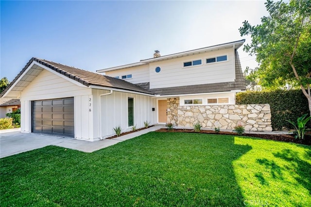 view of front of house with a front yard and a garage