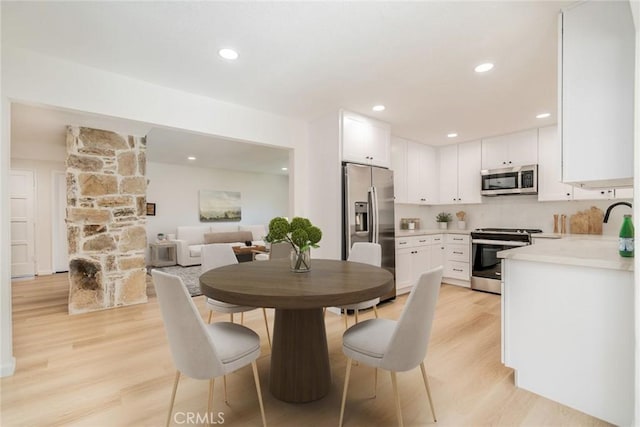 dining area with light hardwood / wood-style flooring