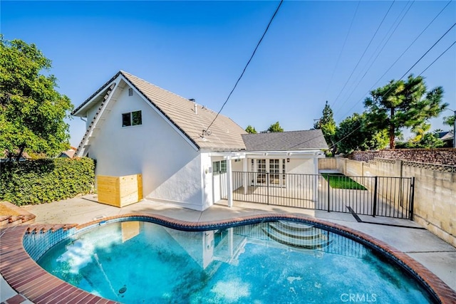 view of swimming pool featuring french doors and a patio area