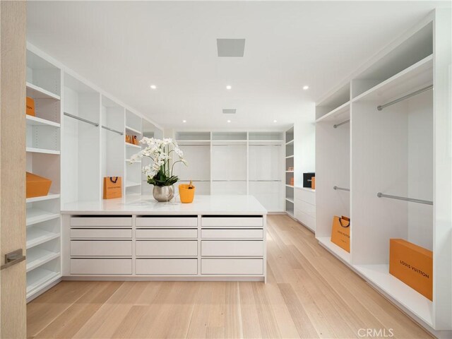 spacious closet featuring light hardwood / wood-style flooring