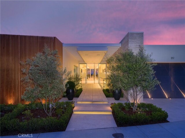 view of exterior entry at dusk