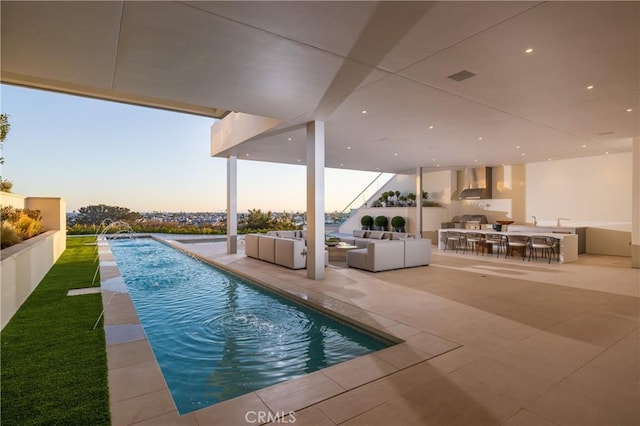 pool at dusk featuring pool water feature