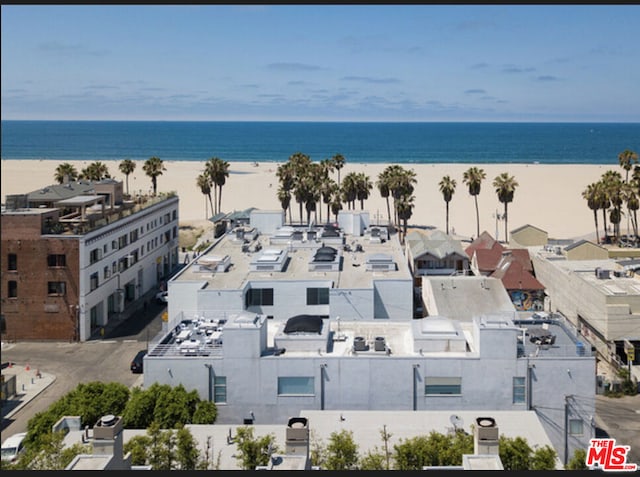 drone / aerial view featuring a water view and a view of the beach