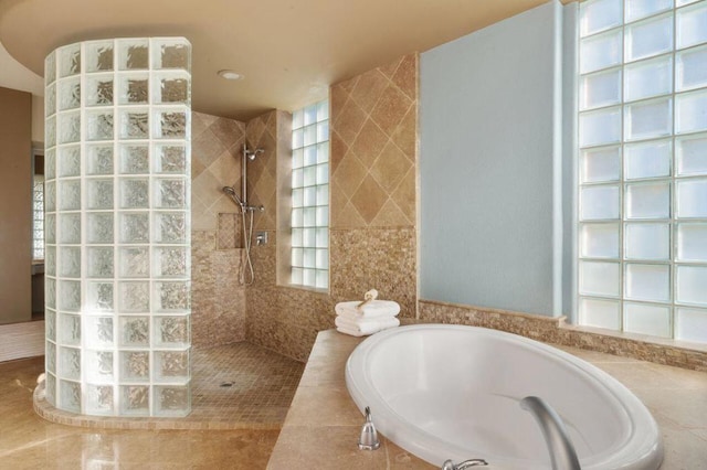 bathroom featuring tile patterned floors and separate shower and tub