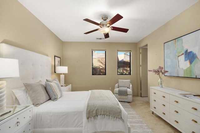 bedroom with ceiling fan and light colored carpet