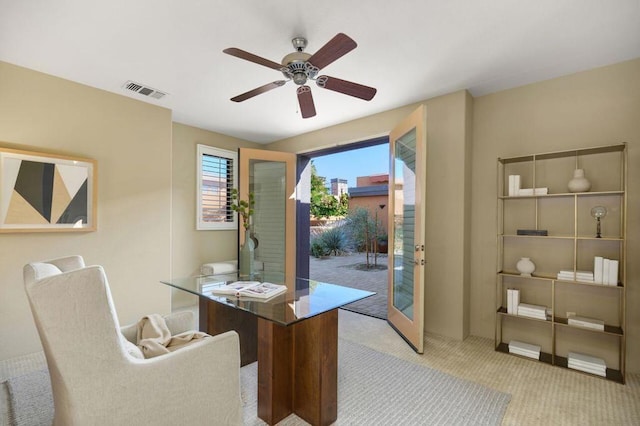 carpeted office featuring french doors and ceiling fan