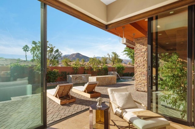 view of patio / terrace with a mountain view and an outdoor living space