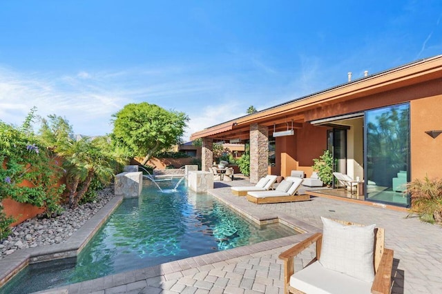 view of swimming pool with pool water feature and a patio area