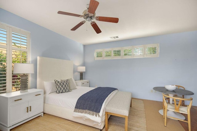 bedroom with light carpet and ceiling fan