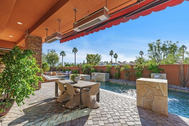 view of patio / terrace featuring pool water feature and a fenced in pool