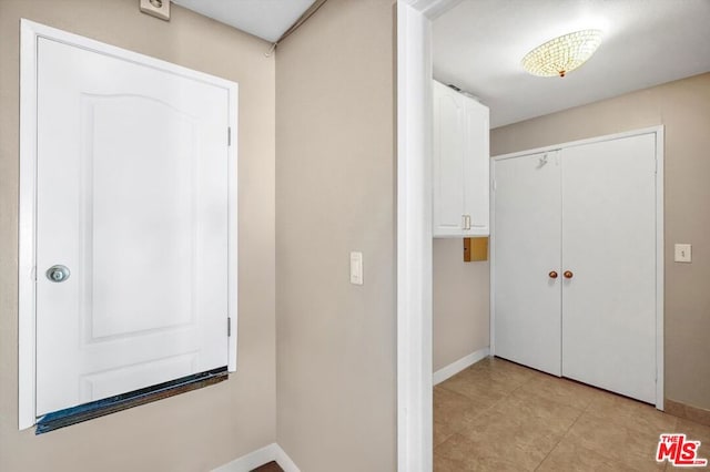 hallway with light tile patterned flooring