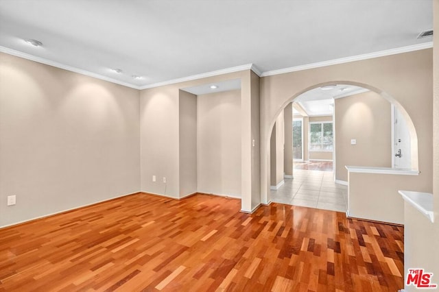 spare room with light hardwood / wood-style floors and ornamental molding