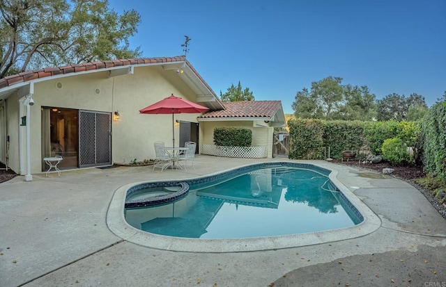 back of property with a fenced in pool and a patio area