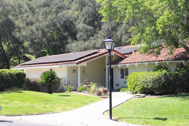 32202 Taupa Way, Pauma Valley, CA 92061 - mediterranean / spanish home with solar panels, a front lawn, and stucco siding