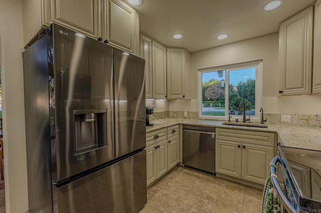 32202 Taupa Way, Pauma Valley, CA 92061 - kitchen with stainless steel appliances, a sink, cream cabinetry, light tile patterned flooring, and light stone counters