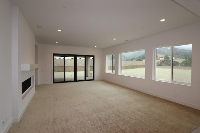 unfurnished living room with light carpet