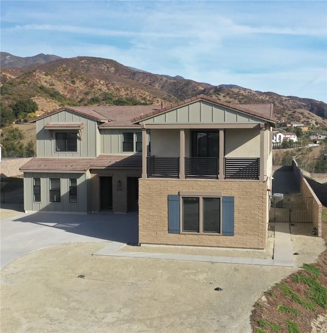 view of front facade featuring a balcony and a mountain view