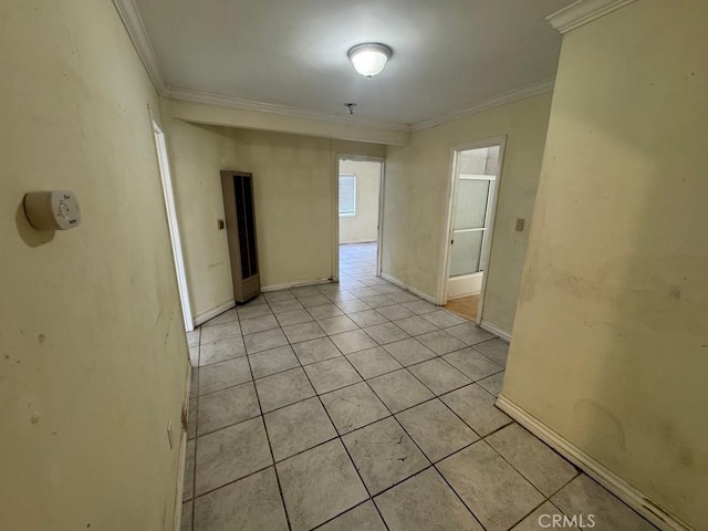 unfurnished room featuring light tile patterned floors and crown molding