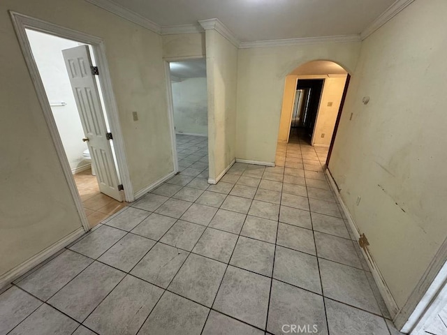 hallway featuring light tile patterned floors and ornamental molding