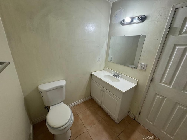 bathroom featuring tile patterned flooring, vanity, and toilet