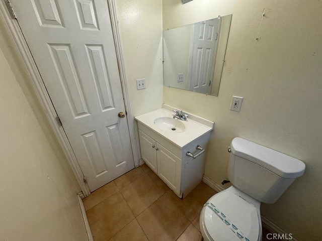 bathroom featuring tile patterned flooring, vanity, and toilet