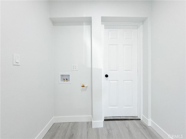 clothes washing area with light hardwood / wood-style floors and hookup for a washing machine