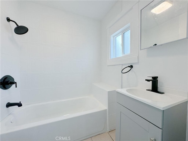 bathroom featuring tile patterned flooring, vanity, and tiled shower / bath