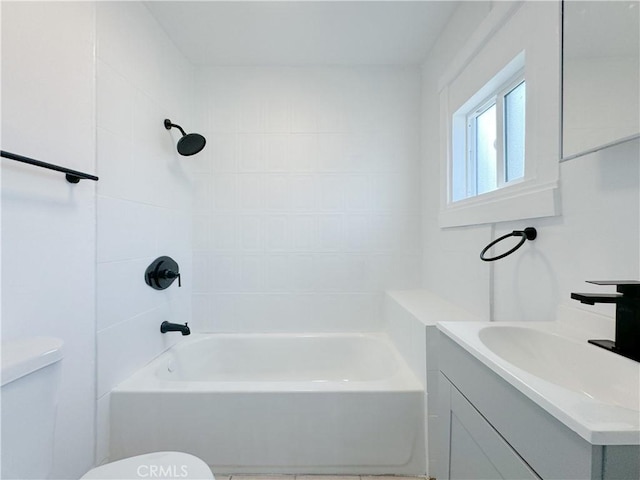 full bathroom with tiled shower / bath combo, toilet, and vanity