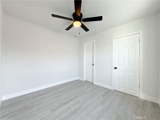 unfurnished bedroom with ceiling fan and light hardwood / wood-style floors