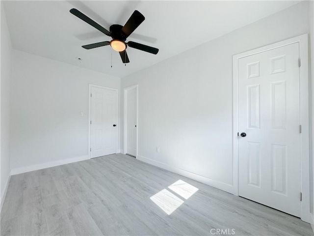 spare room featuring ceiling fan and light wood-type flooring