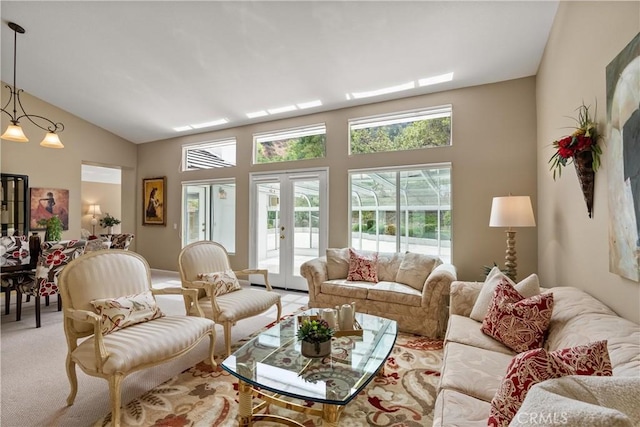 carpeted living room with french doors and lofted ceiling