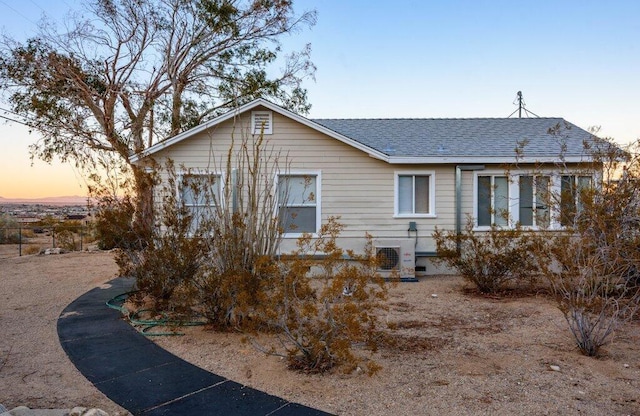 back house at dusk with central AC unit