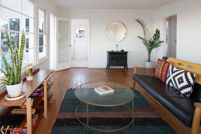 living room featuring hardwood / wood-style flooring and crown molding