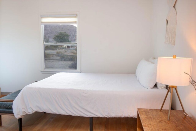 bedroom with hardwood / wood-style flooring