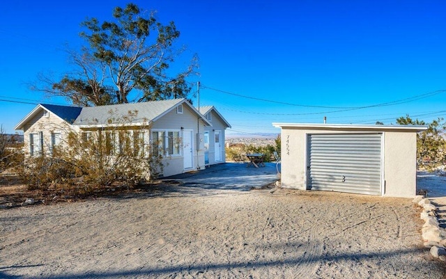 view of home's exterior with a garage and an outdoor structure