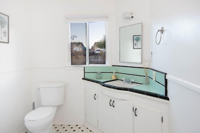 bathroom featuring tile patterned floors, vanity, and toilet