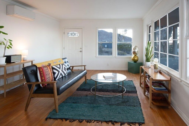 living room with crown molding, hardwood / wood-style floors, and a wall mounted air conditioner