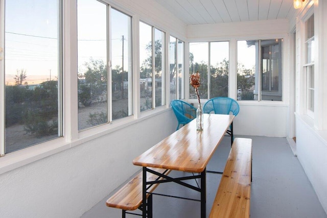 sunroom / solarium with a healthy amount of sunlight and wood ceiling