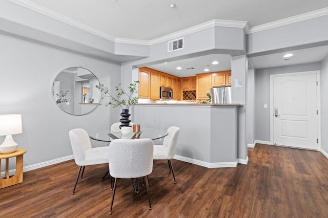 dining space featuring ornamental molding and dark hardwood / wood-style floors