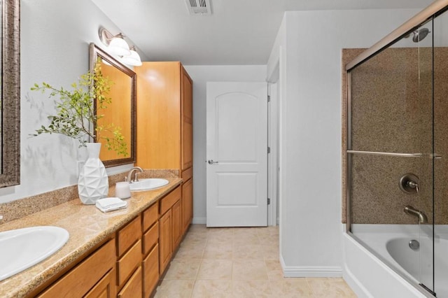 bathroom featuring tile patterned flooring, vanity, and enclosed tub / shower combo