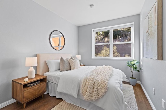 bedroom with dark wood-type flooring