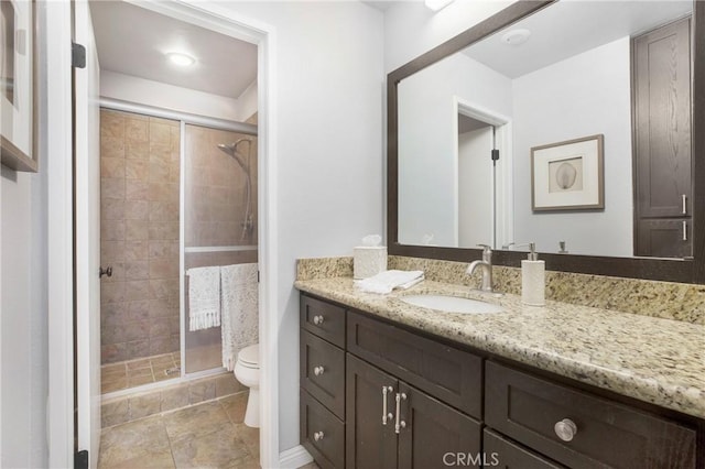 bathroom with vanity, toilet, and a shower with shower door