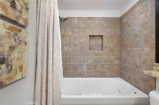 bathroom featuring shower / bath combo with shower curtain and toilet